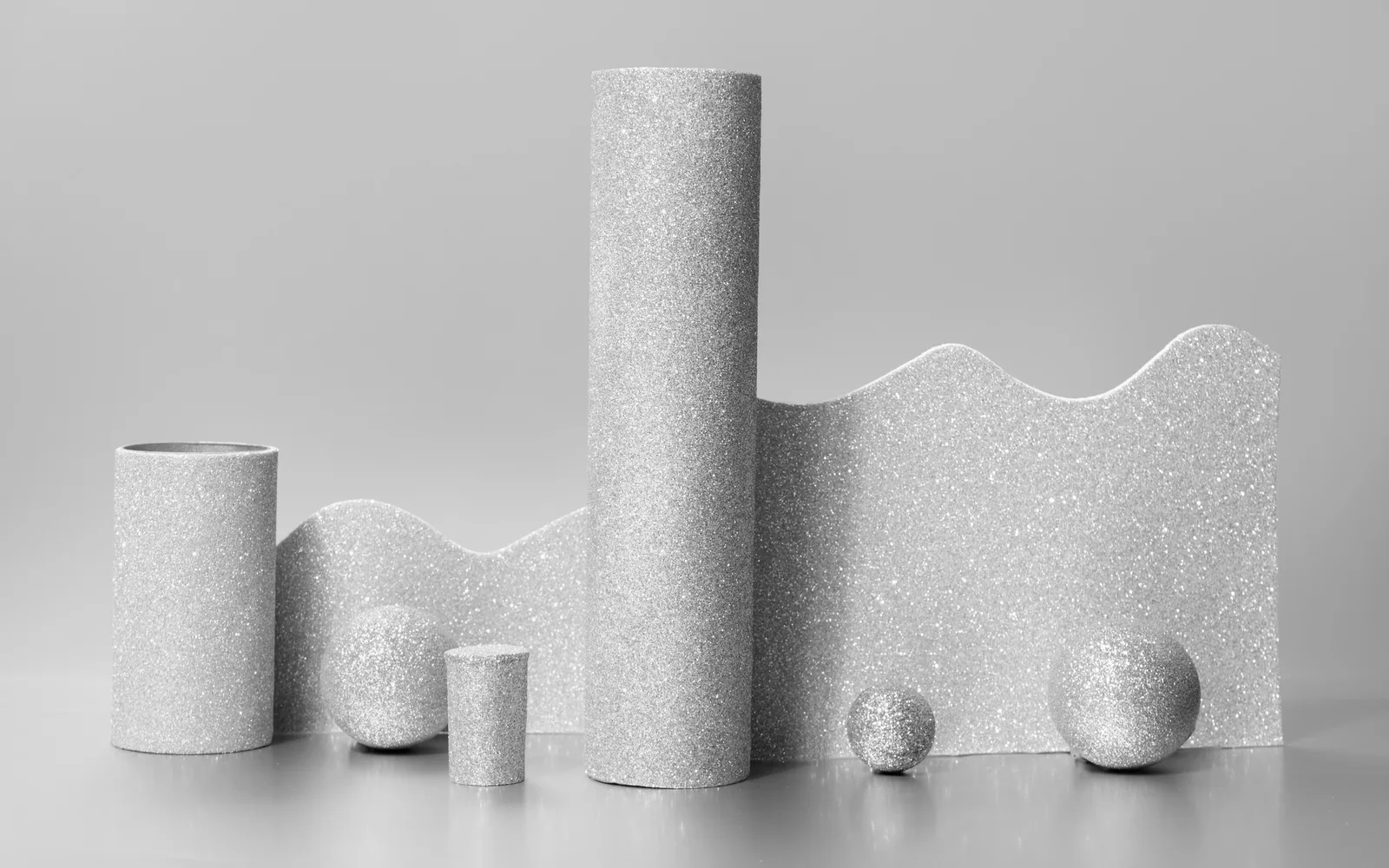 Precise silver architectural forms representing connected clinic systems